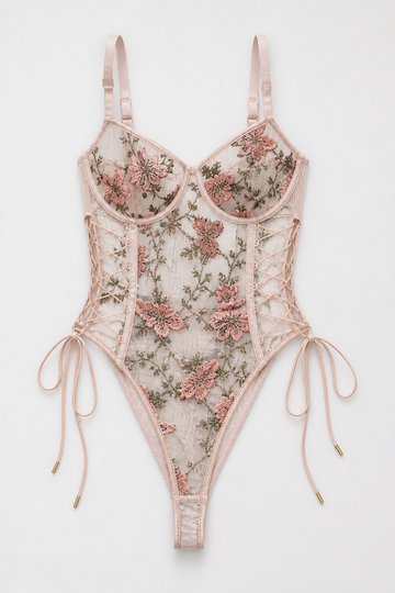 Pink Lunaria embroidered illusion mesh bodysuit with floral details, corset lacing, and adjustable straps.